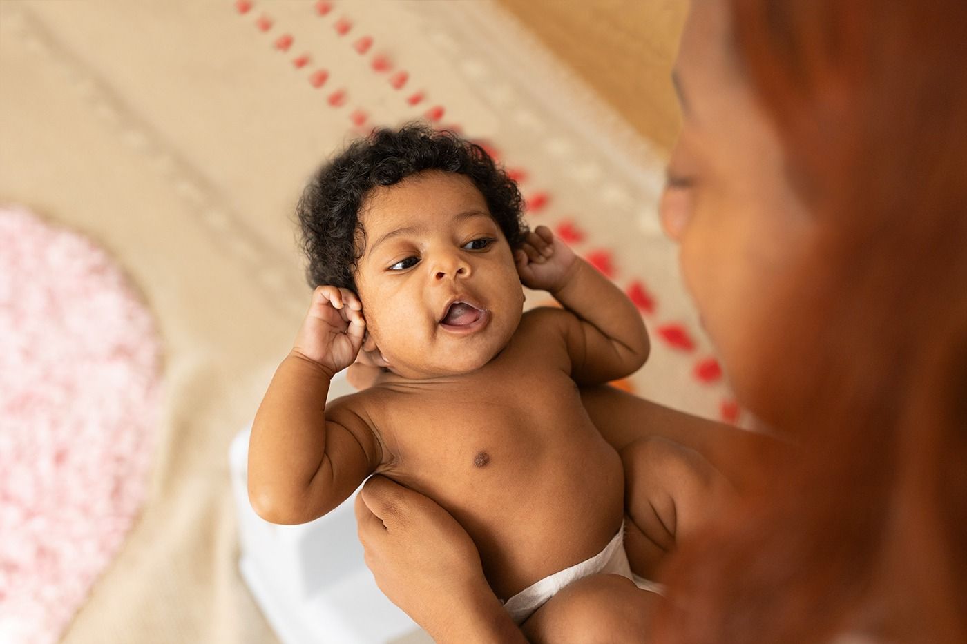Newborn African-American baby girl smiling.