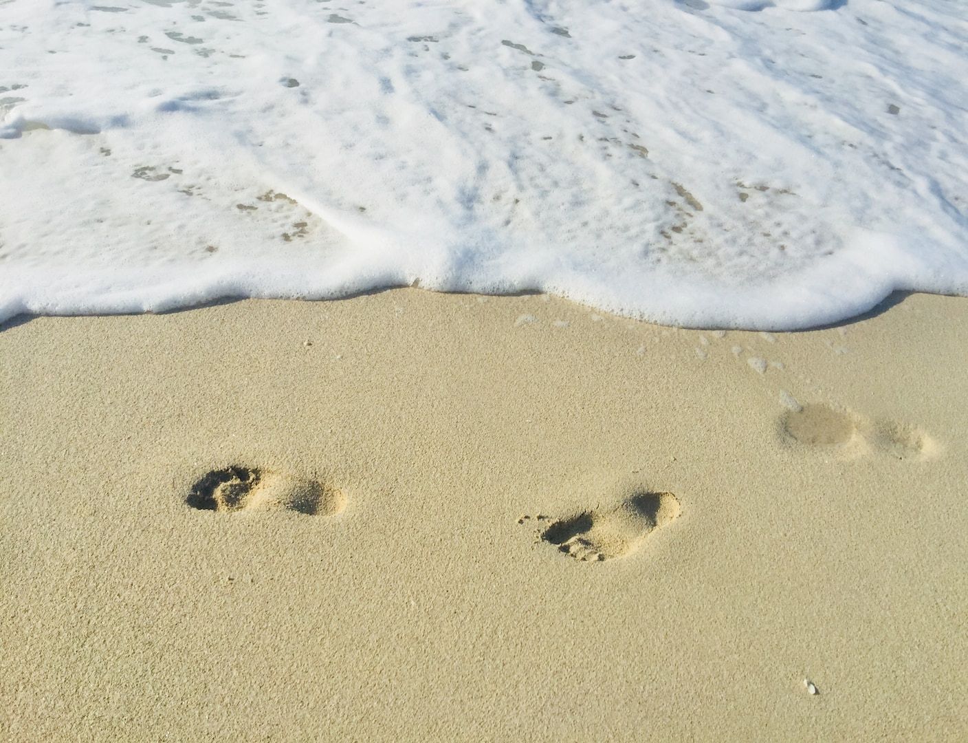 footprints on sand during daytime