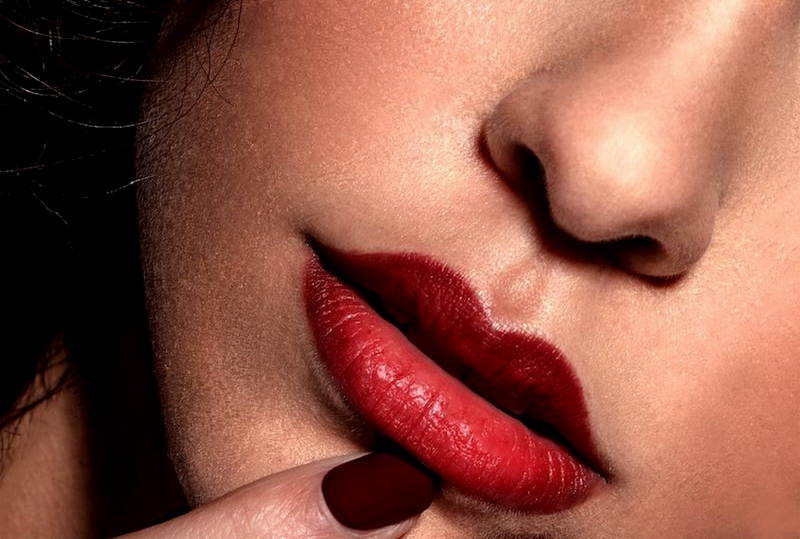 woman with red lipstick and black mascara