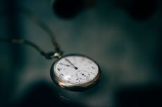 lowlight photography of white pocket watch