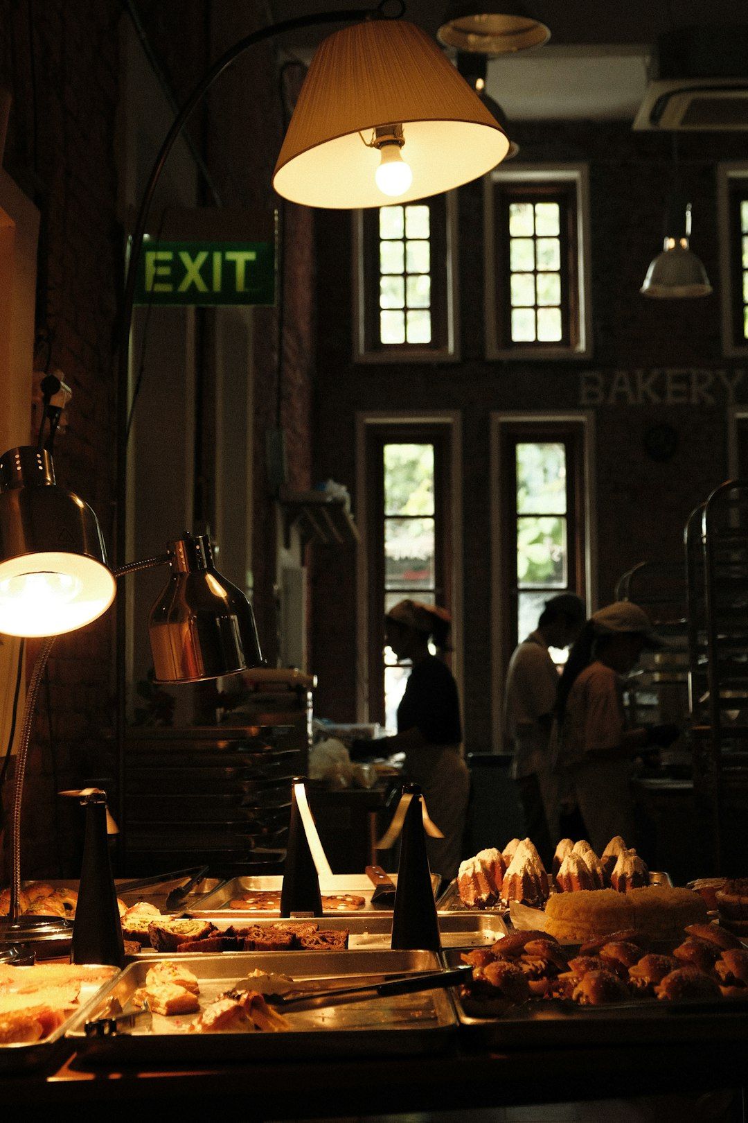 Pastries displayed in a warm bakery with staff working